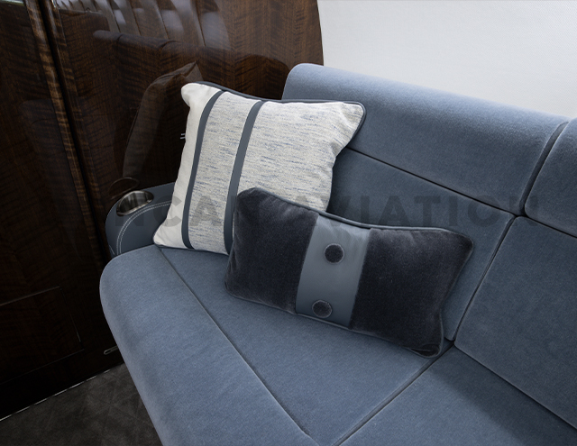 Dusty blue velvet upholstery with accent pillows on divan in Falcon 900