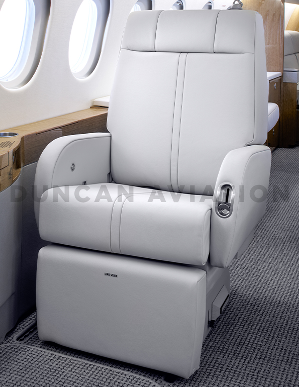 Light gray leather chair in refurbished Falcon 900 by Duncan Aviation