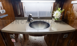 Lav sink in refurbished Falcon 2000 with dark wood and light counters