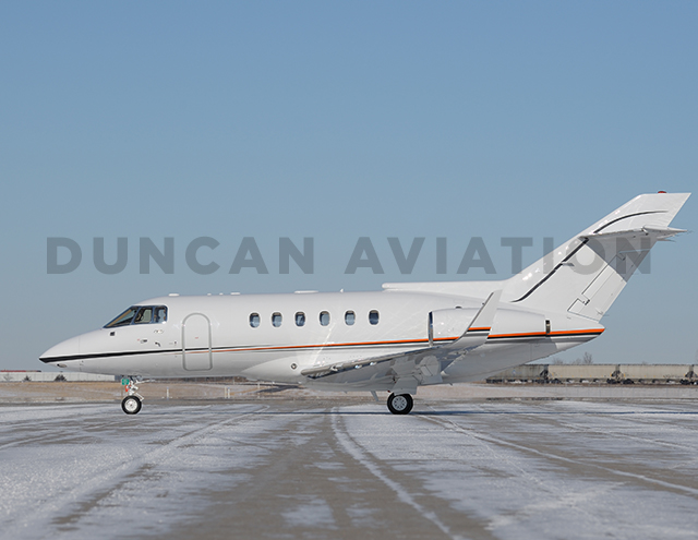 Exterior of Hawker 800 with new white paint and red stripe by Duncan Aviation