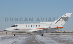 Exterior of Hawker 800 with new white paint and red stripe by Duncan Aviation