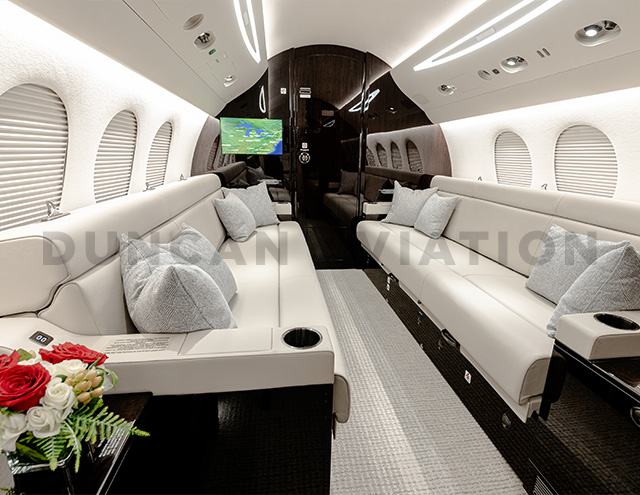 Matching facing cream leather divan couches in newly refurbished Falcon 7X