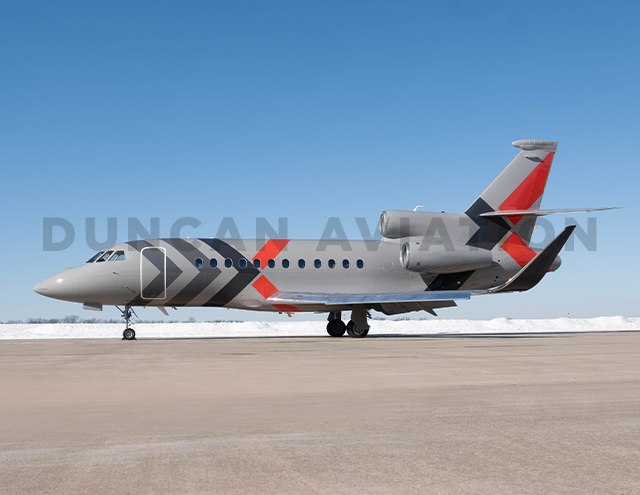 Exterior of Falcon 900 with gray paint and dark gray and red accents in X pattern