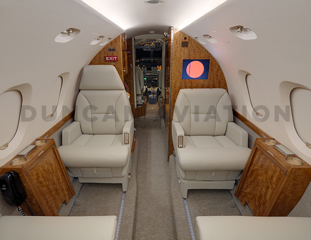 Hawker 800 with refurbished interior by Duncan Aviation with light beige seats and honey wood tones