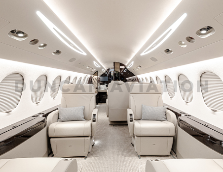 Interior of newly refurbished Falcon 7X in shades of cream by Duncan Aviation